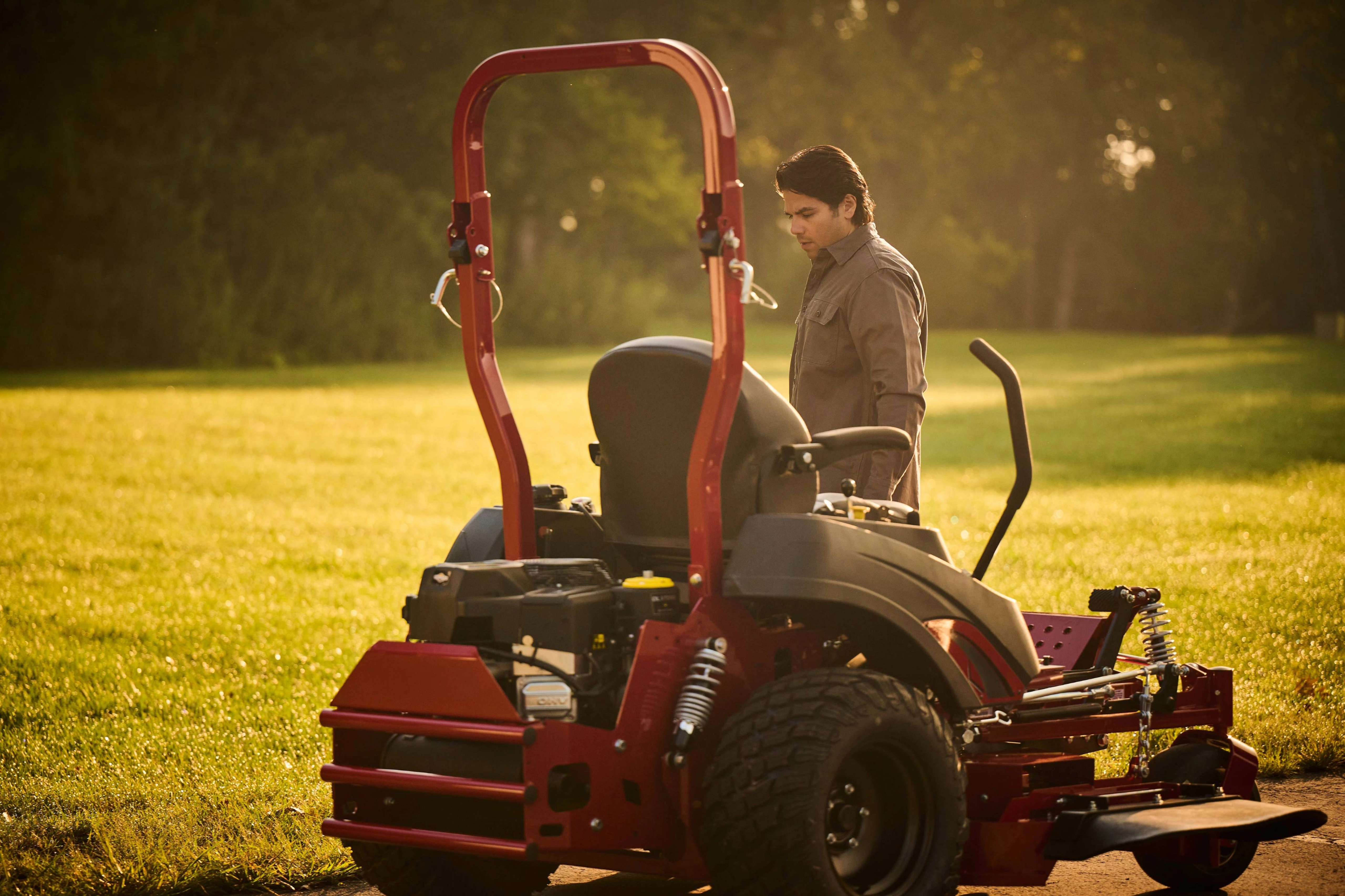 Man walking alongside a Ferris ZTR with a Briggs & Stratton CXi V-twin with Oil Xtend 250-hour maintenance intervals.